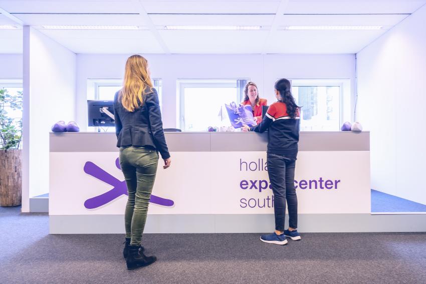 Photo of Holland Expat Center South welcome desk with people